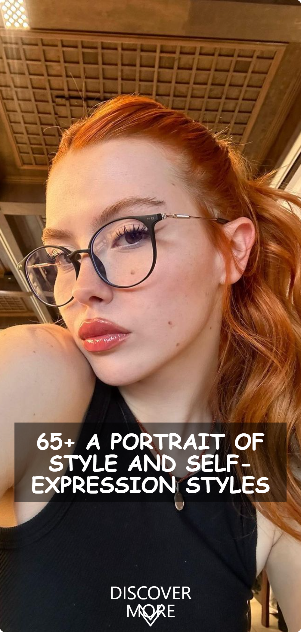 A woman sporting vibrant red hair, glasses, and a black top, exuding a confident and artistic vibe.