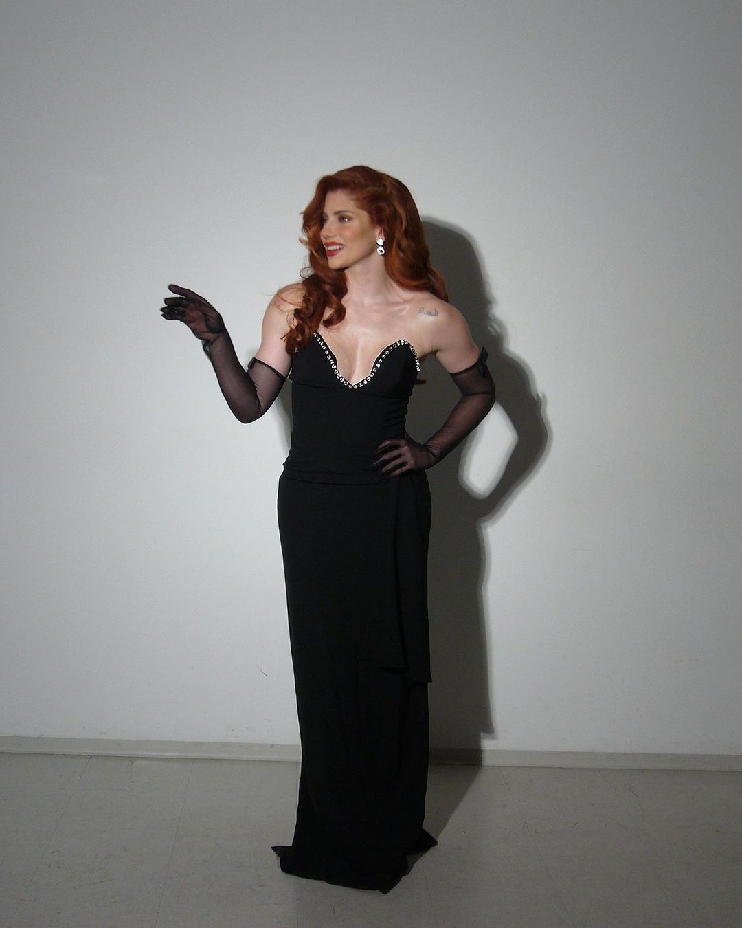 A woman posing confidently in a black gown