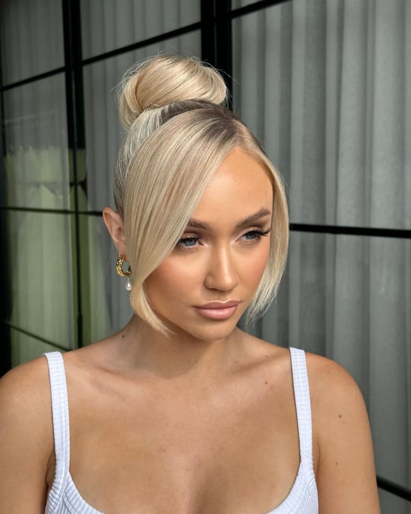 Sleek Blonde Topknot with Side Bang