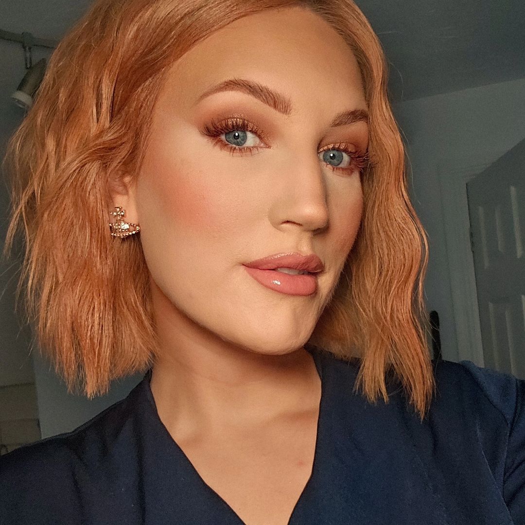 A person showcasing makeup and hairstyle